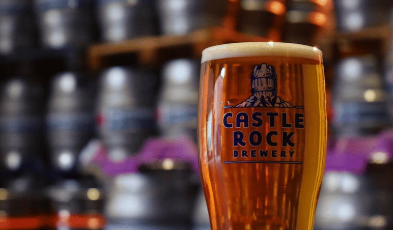 A pint of beer in a branded Castle Rock glass.